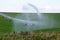 Pivot running in field with beautiful rainbow on sunny day . July 22, 2019, O`Nell, Holt county, Nebraska