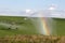 Pivot running in field with beautiful rainbow on sunny day . July 22, 2019, O`Nell, Holt county, Nebraska
