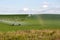 Pivot running in field with beautiful rainbow on sunny day . July 22, 2019, O`Nell, Holt county, Nebraska