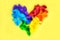 Pixel rainbow heart, like the LGBT rainbow flag on a yellow background with copy space. The concept of human rights