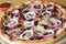 Pizza with bacon, red beans and red onion