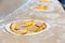 Pizza bases closeup, conveyor, food preparation