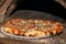 Pizza and brick oven close up