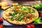 Pizza Caprese with arugula, cheese, yoghurt and cherry tomatoes