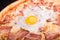 Pizza carbonara with bacon and raw hicken egg