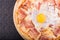 Pizza carbonara with bacon and raw hicken egg