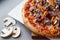 Pizza composition on wooden table with gray background.