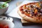 Pizza composition on wooden table with gray background hand.