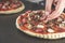 Pizza cooking, meat of chiken, sausage salami, pizza crust, chef prepares delicious pizza, pizza with chicken and