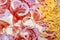 Pizza in the cooking process. Closeup of cheese, onions and sausages with tomatoes. Abstract, tasty background