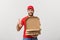 Pizza delivery concept. Young boy is delivering and showing pizza boxs in boxes. Isolated on white background