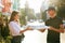 Pizza Delivery. Courier Giving Woman Boxes With Food Outdoors