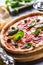 Pizza diavolo traditional italian meal from spicy salami peperoni chili onion olives and basil