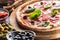 Pizza diavolo traditional italian meal from spicy salami peperoni chili onion olives and basil