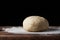 Pizza dough or baking on a dark black background of wood. Baking bread, pizza, pasta. Recipe from chef cooks pizza. Italian home c