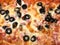 Pizza with ham, cheese, olives closeup. Food background texture