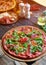 Pizza with ham, tomatoes, spices and fresh arugula. Italian pizza