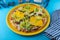 Pizza hamburger with meat shashlik, mustard, lettuce, cheese, sauce. Food in a yellow plate on a blue background. Menu. Homemade
