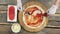 Pizza ingredients on wooden table.