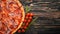 Pizza Lardon. Bacon, cherry tomatoes, sausage salami. On a wooden background.