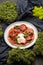 Pizza with large tomatoes. Photo of food on a dark background