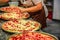 Pizza maker preparing pizzas