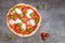 Pizza margherita on dark background. Traditional italian pizza, top view. Takeaway food