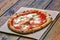 Pizza Margherita on rustic wooden table