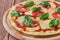 Pizza Margherita with tomatoes, mozzarella and basil