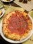 pizza meat circle slice tasty hot pepperoni covered tomatoes with prosciutto and spices on plate