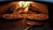 pizza with mozzarella cheese is baked in an open firewood oven. Cooking pizza in a brick oven. Pizzeria baking