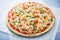 Pizza with mozzarella cheese, chicken, sweet corn, sweet pepper and parsley