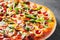 Pizza with Mozzarella cheese, mushrooms, ham, tomato sauce, sausage, pepper, Spices and Fresh arugula