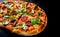 Pizza with Mozzarella cheese, salami, Tomato sauce, pepper, Spices and Fresh arugula. Italian pizza on Dark grey black slate backg