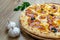 Pizza with mozzarella cheese, truffles, onion, ham and corn detail