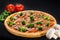 Pizza with mozzarella, mushroom, broccoli, onion and tomatoes on