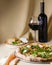 Pizza with mozzarella, salmon slices, fresh arugula. Served with baked cheese camembert and red wine. Italian cuisine