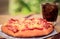 Pizza picture with a glass of sparkling water. Blurred background
