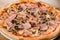 Pizza prosciutto e funghi, traditional italian oven baked: tomato sauce, mozzarella, ham, mushrooms