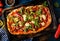 Pizza with prosciutto, mozzarella, mushroom and rocket salad wit