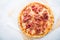 Pizza with prosciutto (parma ham) on white background top view