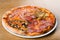 Pizza quattro stagioni is a variety of pizza in Italian cuisine that is prepared in four sections