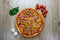 Pizza with red sauce, ham, mozarella, corn, onion rings, red bell pepper, mushroom top