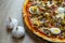 Pizza with red sauce, mozarella, ham, mushroom, boiled egg, green olives detail