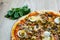 Pizza with red sauce, mozarella, ham, mushroom, boiled egg, green olives detail