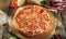 Pizza Restaurant Menu - Delicious Fresh Margarita Pizza with. Pizza on Rustic Wooden Table