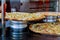 Pizza resting on a pizzeria counter the background is restaurant