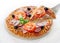 Pizza with salami, bacon, tomato and black olives