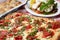 Pizza square with crushed tomatoes, fresh mozzarella ,garlic knots