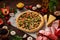 Pizza still life. Freshly baked pizza and its components arranged on wooden background.